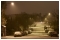 December 2010: An evening snow shower on Mile End Road, Colchester creates a leopardskin illumination pattern on the road